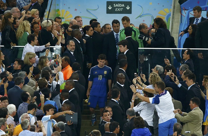 Fans take pictures of Argentina's Lionel Messi after he was awarded the Golden Ball at the end of their 2014 World Cup final against Germany at the Maracana stadium in Rio de Janeiro
